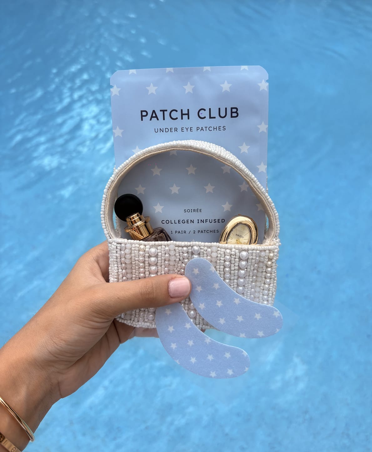 Patch Club Soirée sachet and patches in a beaded bag by the pool